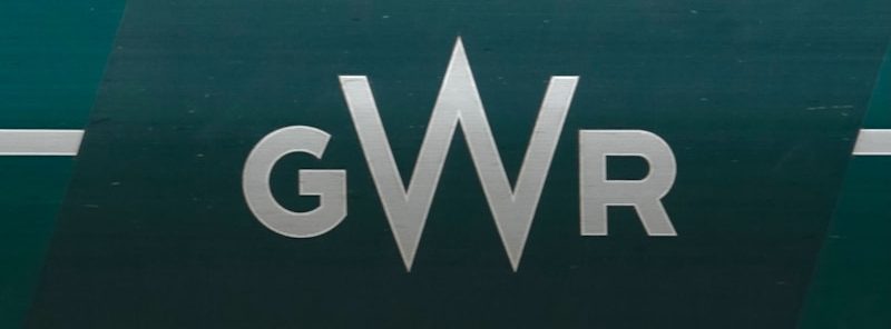 People sit inside a train window.
